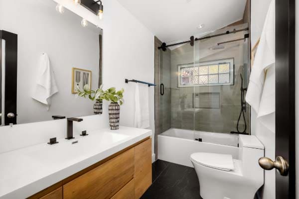 Smart bathroom technology including voice-activated mirror and touchless fixtures