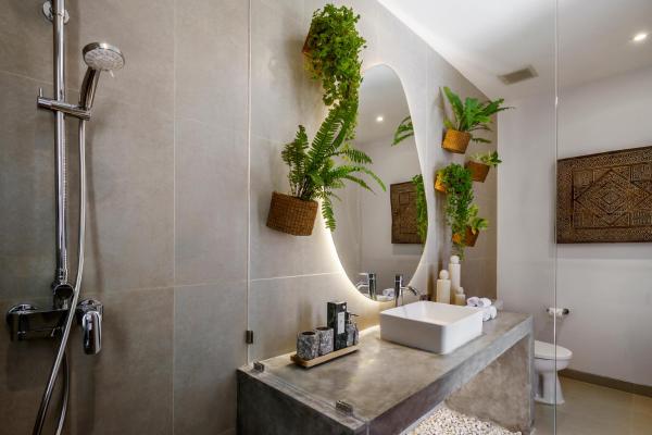 Smart bathroom technology including touchless fixtures, voice controls, and digital mirror displays